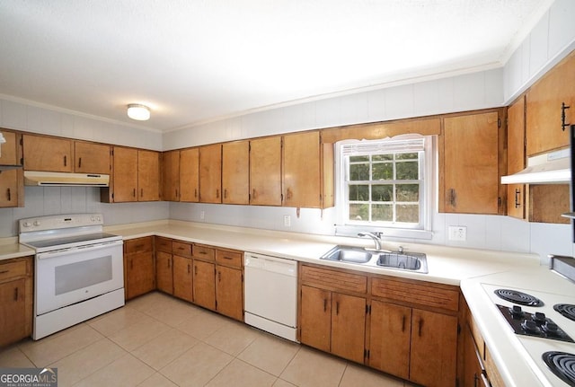 kitchen with white appliances, sink, light tile patterned floors, and ornamental molding