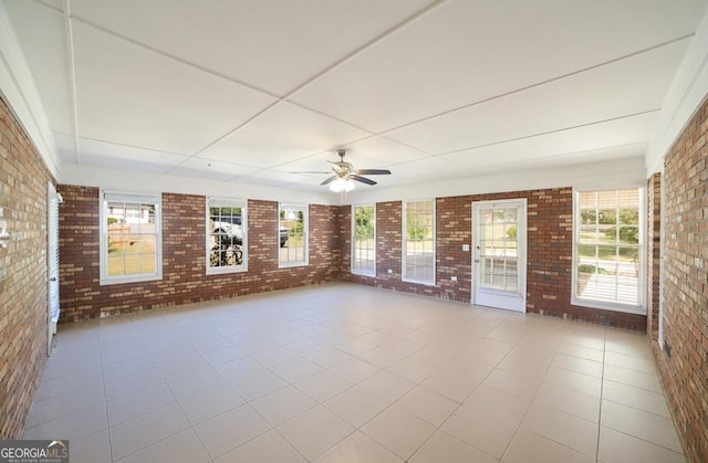 interior space with ceiling fan