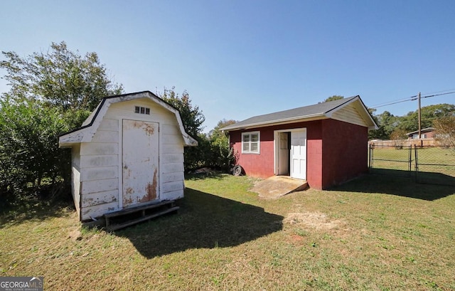 view of outbuilding featuring a lawn