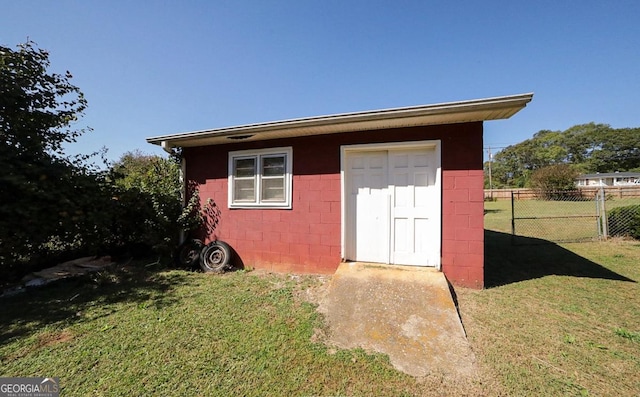 view of outbuilding featuring a yard