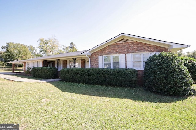 ranch-style home featuring a front yard