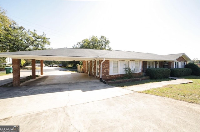 ranch-style home featuring a carport