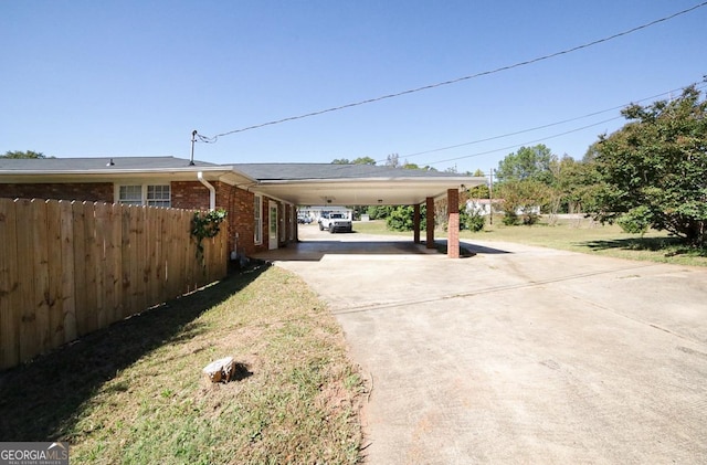 exterior space with a yard and a carport