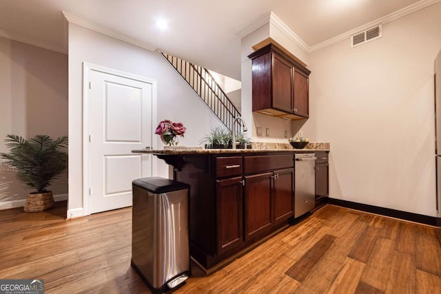 bar with ornamental molding, dark brown cabinetry, sink, light hardwood / wood-style flooring, and dishwasher