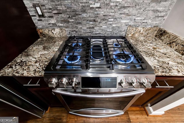 room details featuring stone counters and double oven range