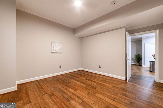 spare room with wood-type flooring and ornamental molding