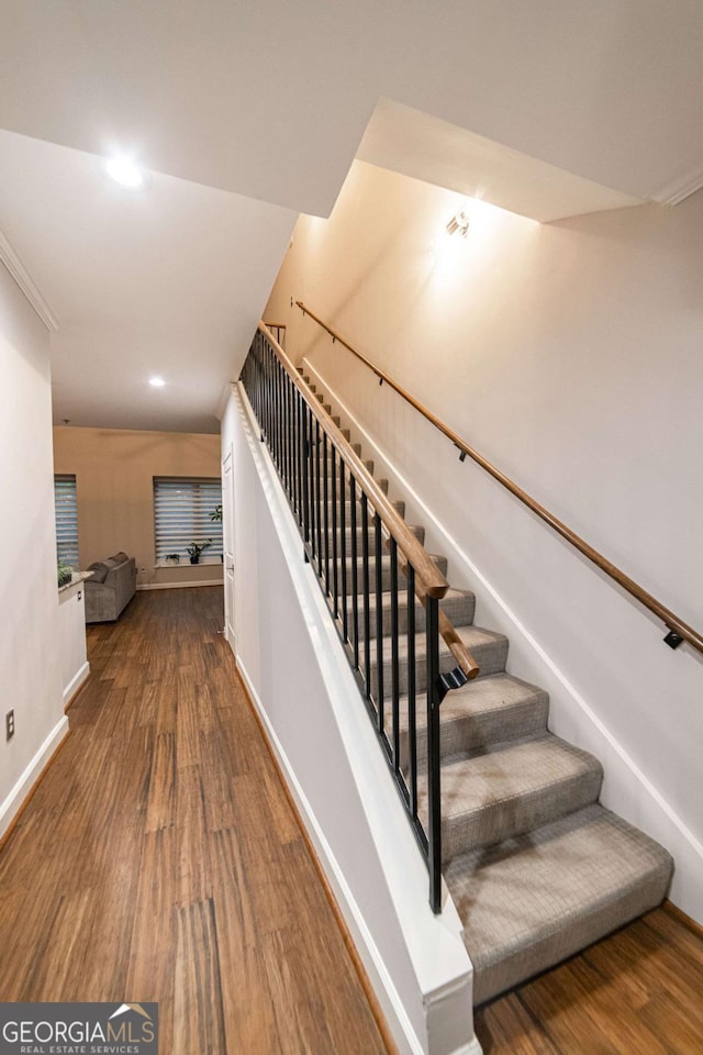 staircase with wood-type flooring