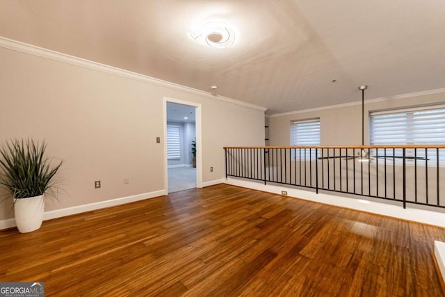 unfurnished room featuring hardwood / wood-style floors and crown molding