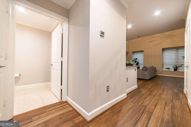 hall featuring light hardwood / wood-style floors and ornamental molding