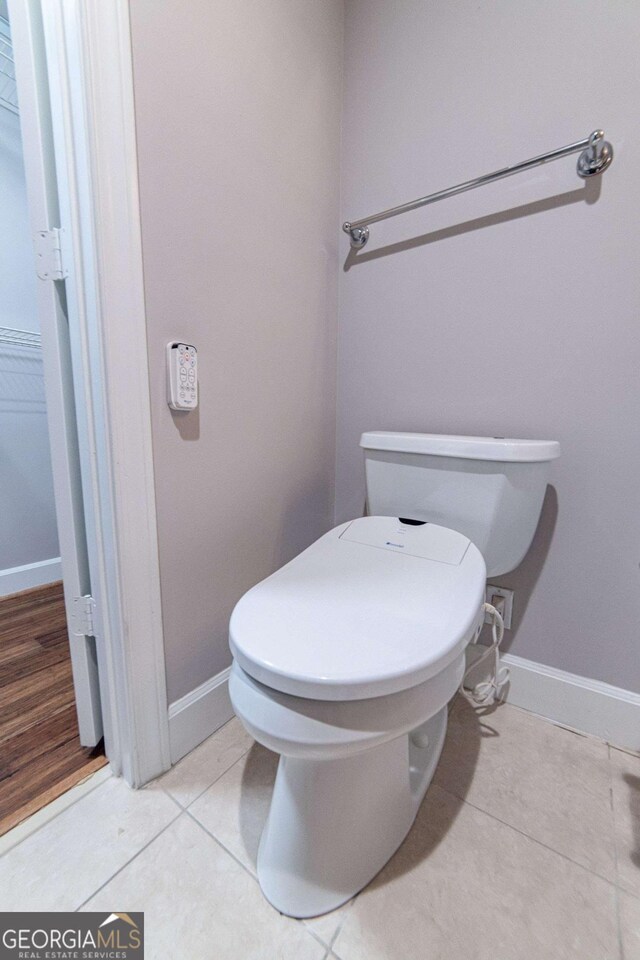 bathroom with tile patterned flooring and toilet