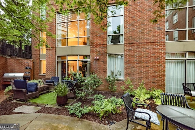 rear view of property featuring an outdoor hangout area and a patio