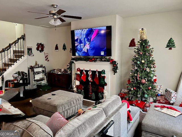 living room featuring ceiling fan and hardwood / wood-style flooring