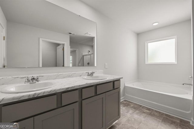 bathroom featuring vanity and shower with separate bathtub