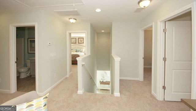 hall with light colored carpet