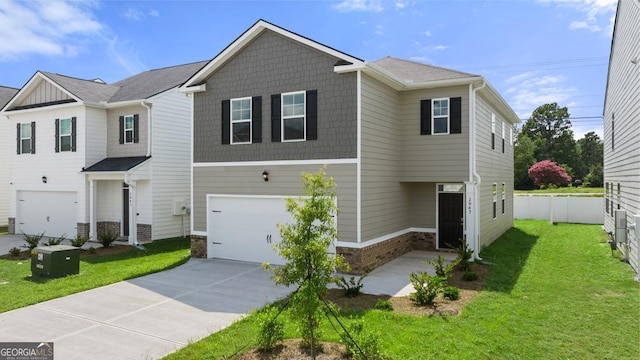 view of front of house featuring a front yard and a garage