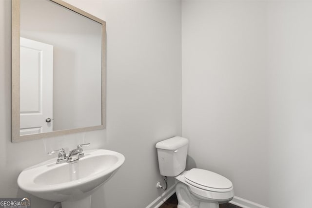 bathroom featuring toilet and sink