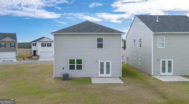 back of house with a lawn, cooling unit, a patio area, and french doors