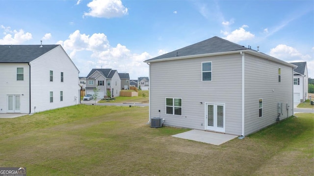 back of house featuring a patio area and a lawn