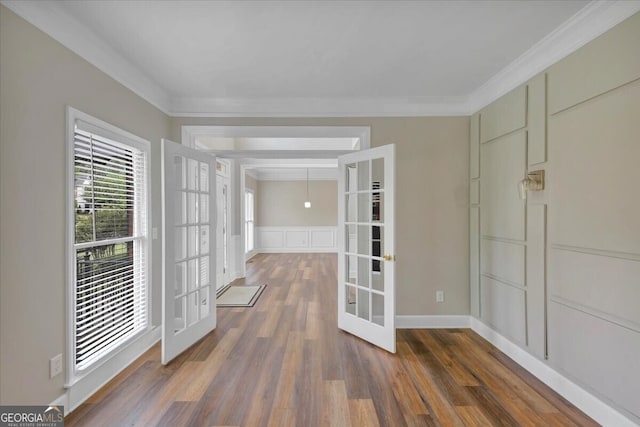 empty room with french doors, dark hardwood / wood-style flooring, and ornamental molding