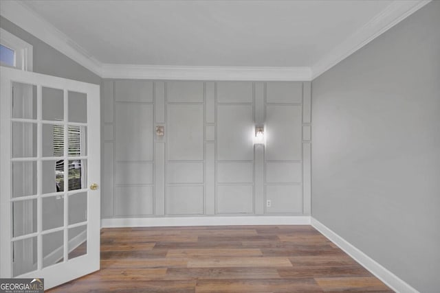 empty room featuring hardwood / wood-style flooring and crown molding