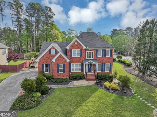 colonial inspired home featuring a front yard