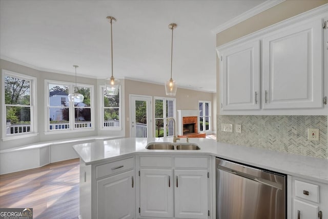 kitchen featuring dishwasher, white cabinetry, and sink