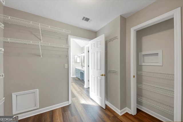 walk in closet featuring dark hardwood / wood-style flooring