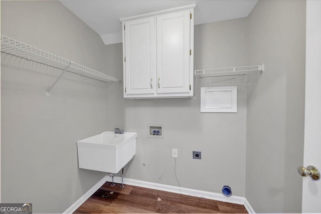 laundry room with electric dryer hookup, cabinets, sink, hookup for a washing machine, and wood-type flooring