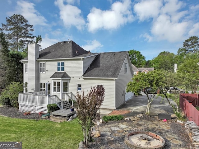 back of house with a yard, a patio, a deck, and an outdoor fire pit