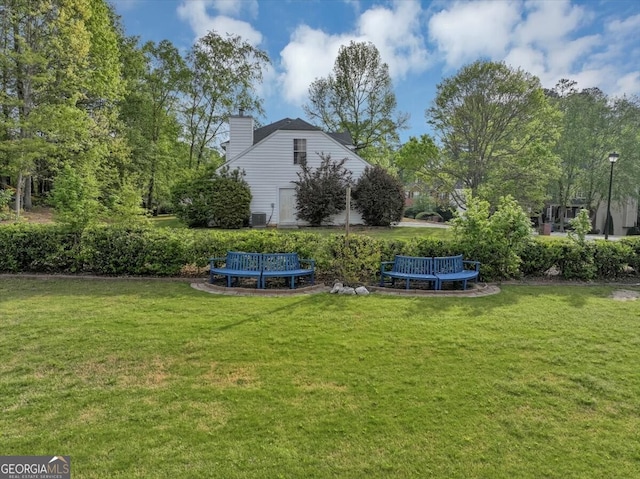 view of yard with a trampoline and central air condition unit