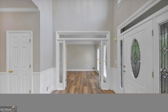 entryway featuring dark hardwood / wood-style flooring, crown molding, and a healthy amount of sunlight