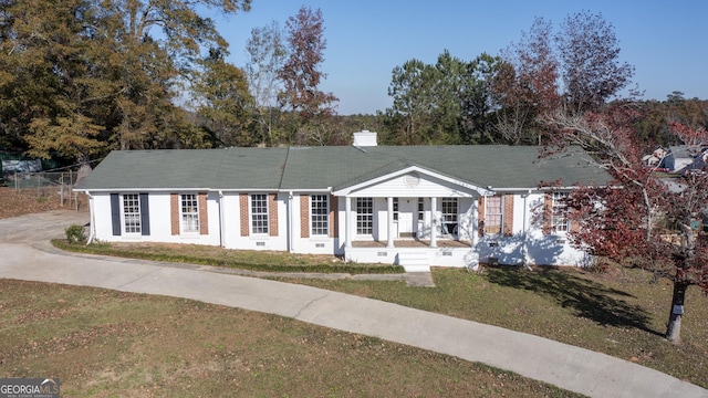 view of front of property with covered porch and a front yard