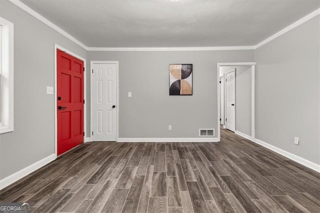 entrance foyer with crown molding and dark wood-type flooring