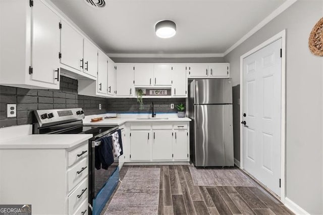 kitchen featuring sink, dark hardwood / wood-style flooring, decorative backsplash, white cabinets, and appliances with stainless steel finishes