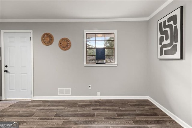 unfurnished room with dark hardwood / wood-style floors and ornamental molding