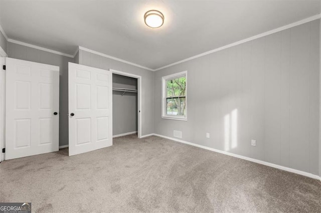 unfurnished bedroom featuring light colored carpet and ornamental molding