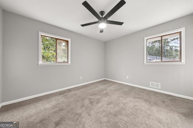 unfurnished room featuring ceiling fan and carpet floors