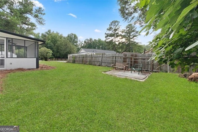 view of yard featuring a sunroom and a patio area