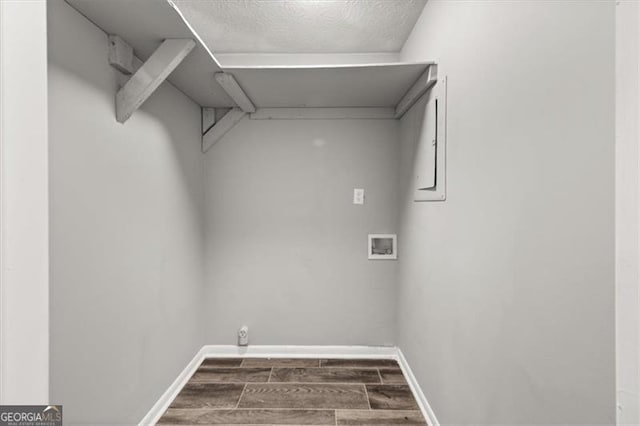 laundry room with washer hookup, dark hardwood / wood-style floors, and a textured ceiling