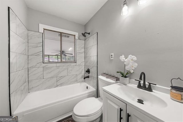 full bathroom with vanity, toilet, and tiled shower / bath