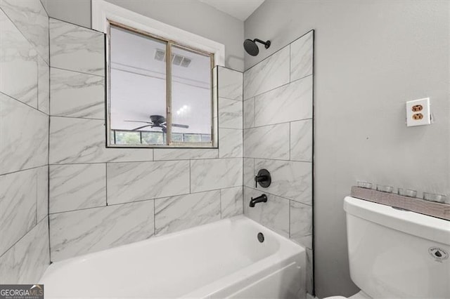 bathroom featuring toilet, tiled shower / bath, and ceiling fan