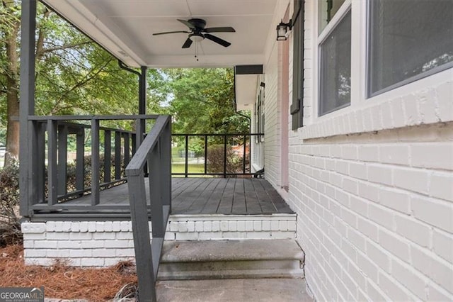 deck with ceiling fan and covered porch