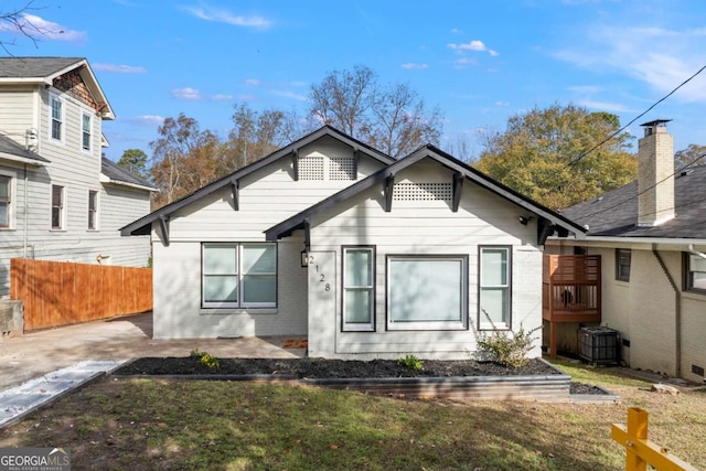 bungalow with a patio, central AC unit, and a front lawn