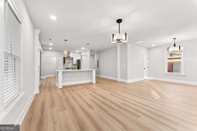 unfurnished living room featuring light hardwood / wood-style floors