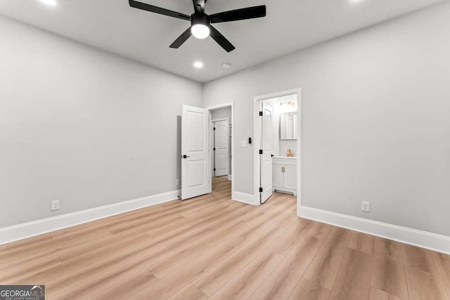 unfurnished bedroom with light wood-type flooring, ensuite bathroom, and ceiling fan