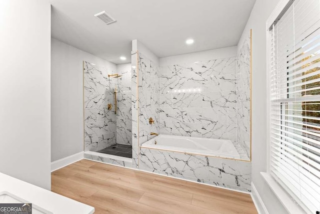 bathroom with separate shower and tub and wood-type flooring