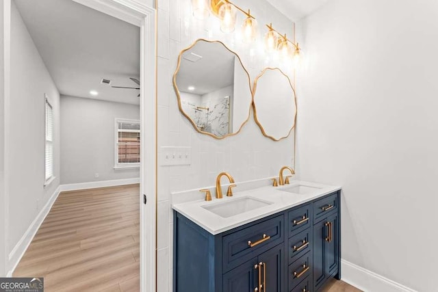 bathroom featuring ceiling fan, hardwood / wood-style floors, and vanity