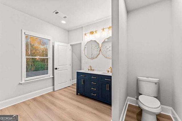 bathroom featuring hardwood / wood-style floors, vanity, and toilet