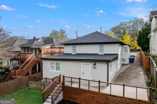 rear view of house featuring a patio and a deck