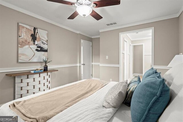 bedroom with ceiling fan and ornamental molding